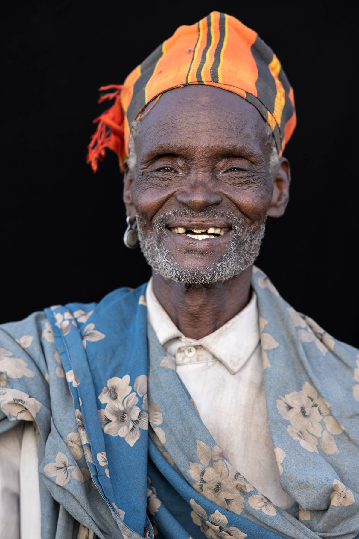 An Arbore elder who was eager to be photographed, offering a warm smile shaped by a lifetime of stories. (image by Ingrid Koedood)