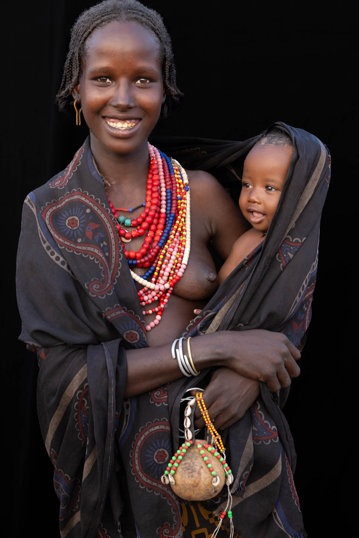 Carried close, where warmth meets wonder. A moment between an Arbore mother and her child. (image by Ingrid Koedood)