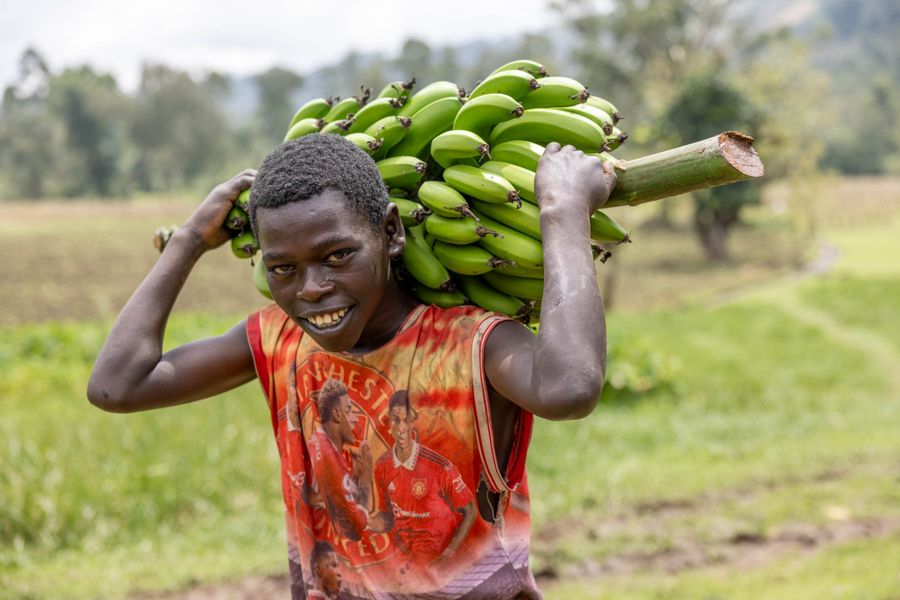 On his way to the market, carrying freshly harvested bananas. A young boy fr0m the Ari tribe, where farming is woven into everyday life. (image by Ingrid Koedood)