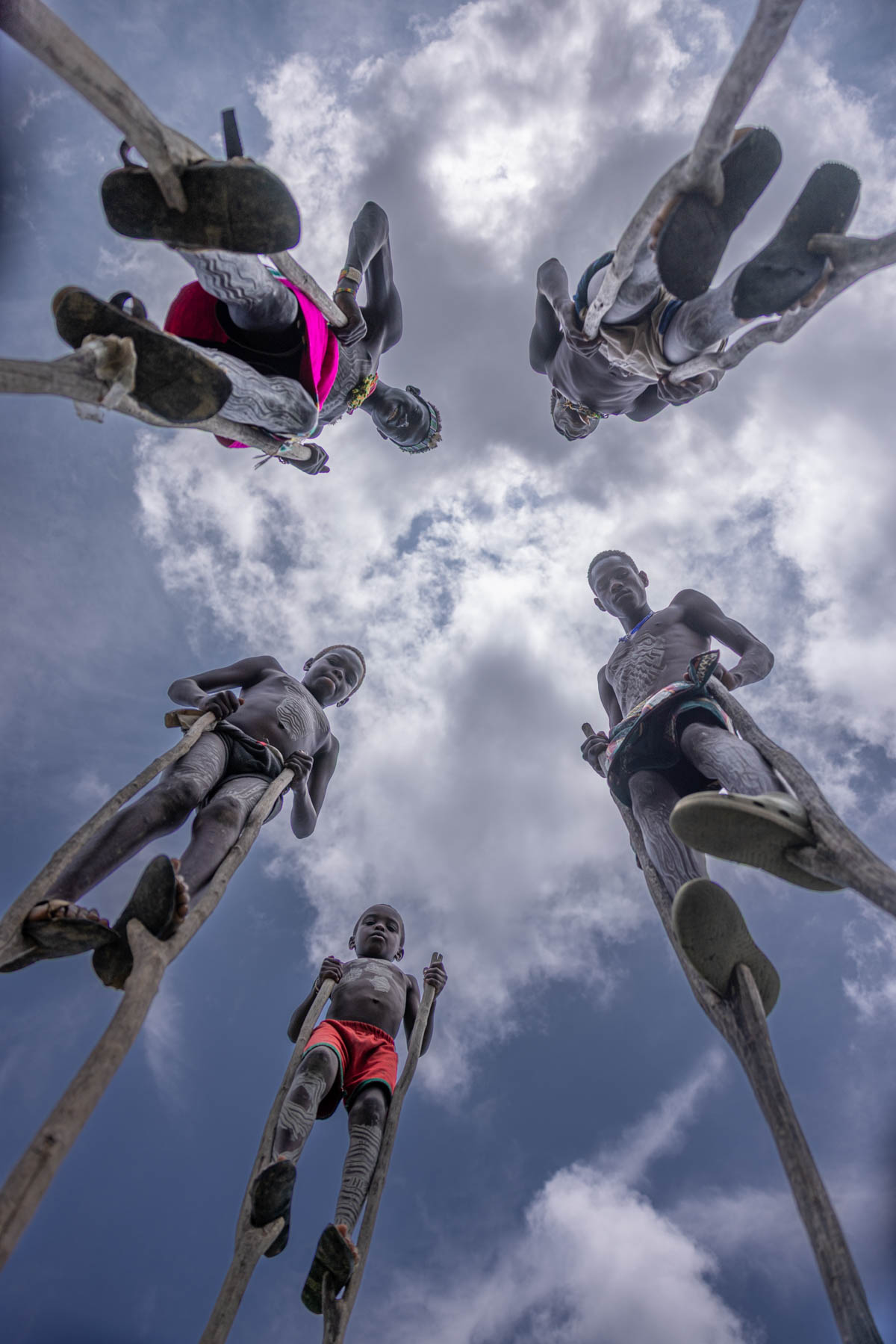Photo of the Banna boys on their wooden stilts, with me lying on the ground to capture the shot (image by Ingrid Koedood)