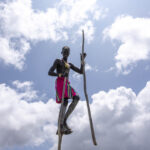 A Banna boy on stilts, rising above the earth, for a moment, it feels as if he is playing among the clouds. (image by Ingrid Koedood)