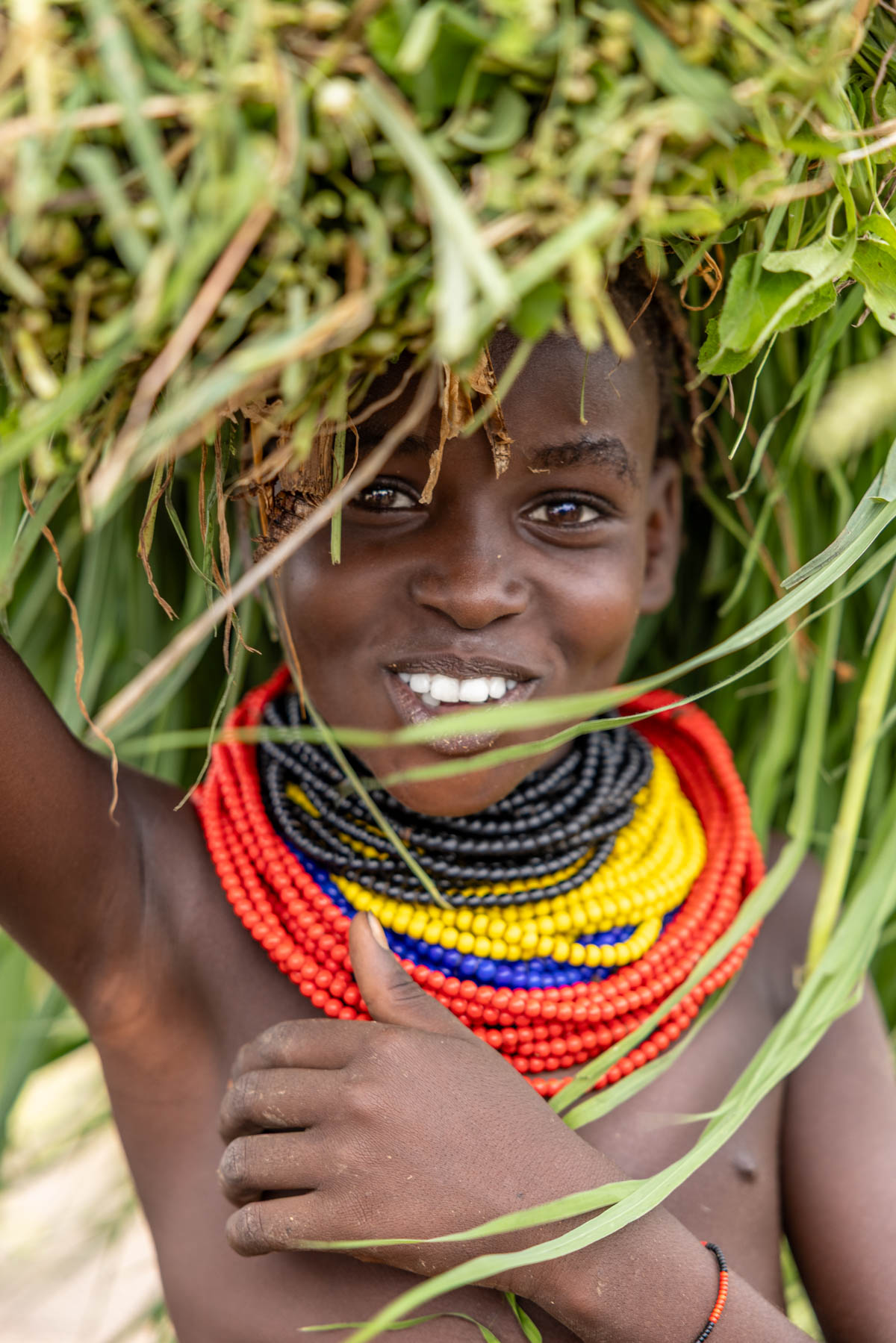 On the way to the Dassanech tribe, we saw many people carrying fresh grass after the rains. (image by Ingrid Koedood)