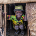 From the doorway of his hut, a Dassanech boy watches the Dimi ceremony preparations. (image by Ingrid Koedood)