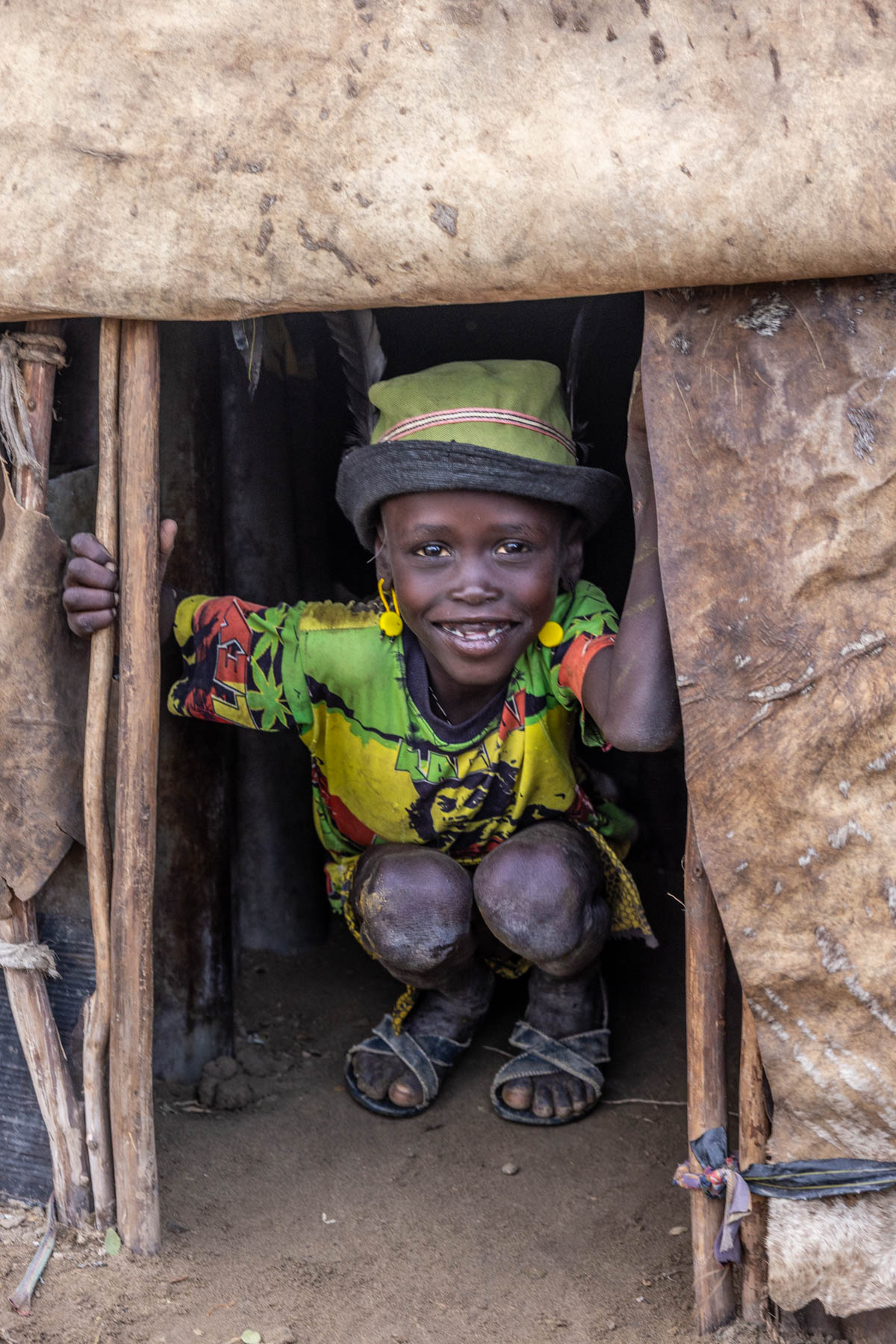 From the doorway of his hut, a Dassanech boy watches the Dimi ceremony preparations. (image by Ingrid Koedood)