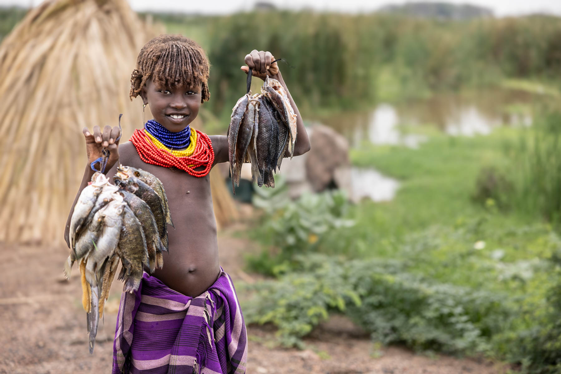 Dassanech girl proudly showing today’s catch. (image by Ingrid Koedood)