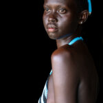 Nyanda wearing Dinka wedding beads (image by Inger Vandyke)