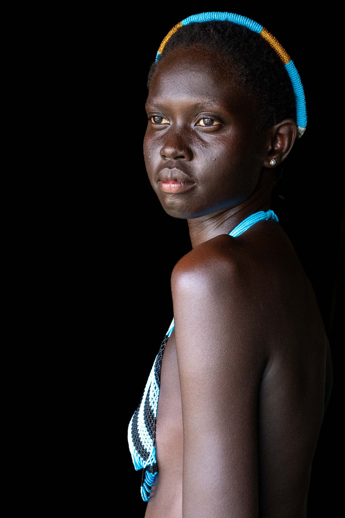 Nyanda wearing Dinka wedding beads (image by Inger Vandyke)