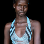 Aker wearing a Dinka crown and necklace (image by Inger Vandyke)