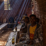 Men gathering in a Tej (honey wine) bar in Dorze, sharing honey wine. (image by Ingrid Koedood)