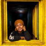 Portrait of a young woman posing in a window of a bar in Dorze (image by Ingrid Koedood)