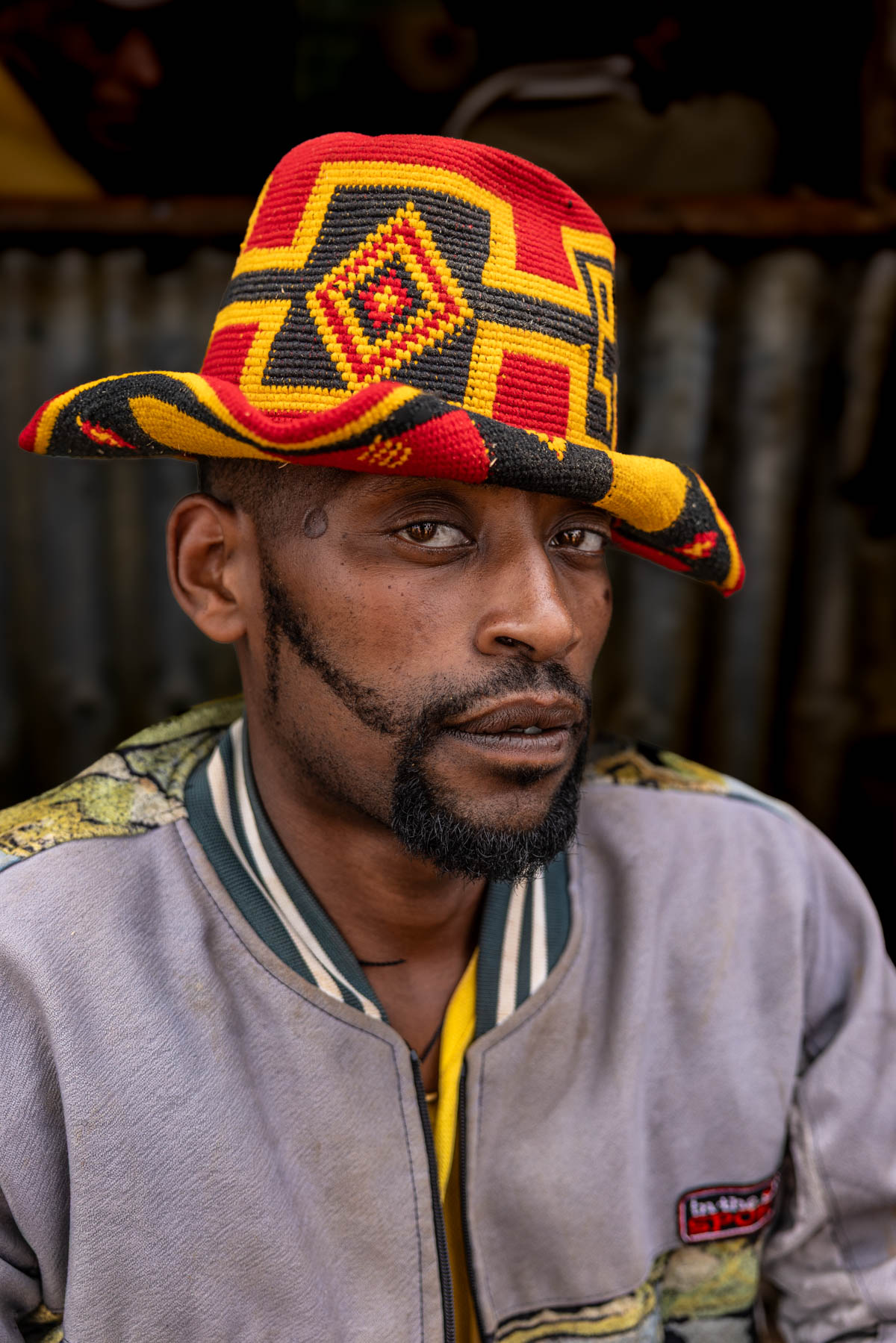 Portrait of a man in front of a honey wine bar in Dorze, wearing a traditional hat. (image by Ingrid Koedood)