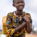 Young Dorze girl carrying a heavy container of water. (image by Ingrid Koedood)