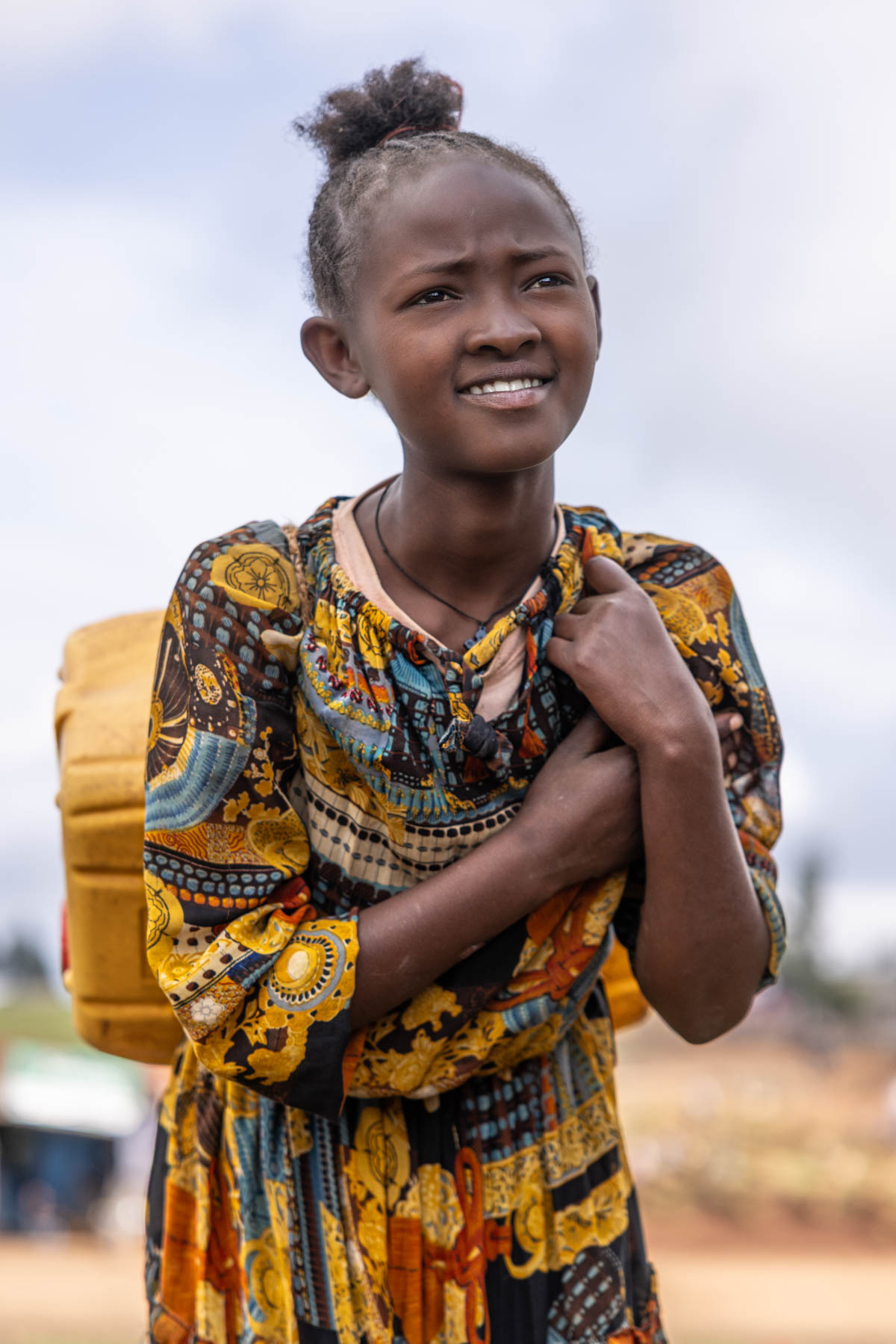 Young Dorze girl carrying a heavy container of water. (image by Ingrid Koedood)