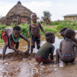 After the rain, the Hamar children play freely in water and mud. (image by Ingrid Koedood)