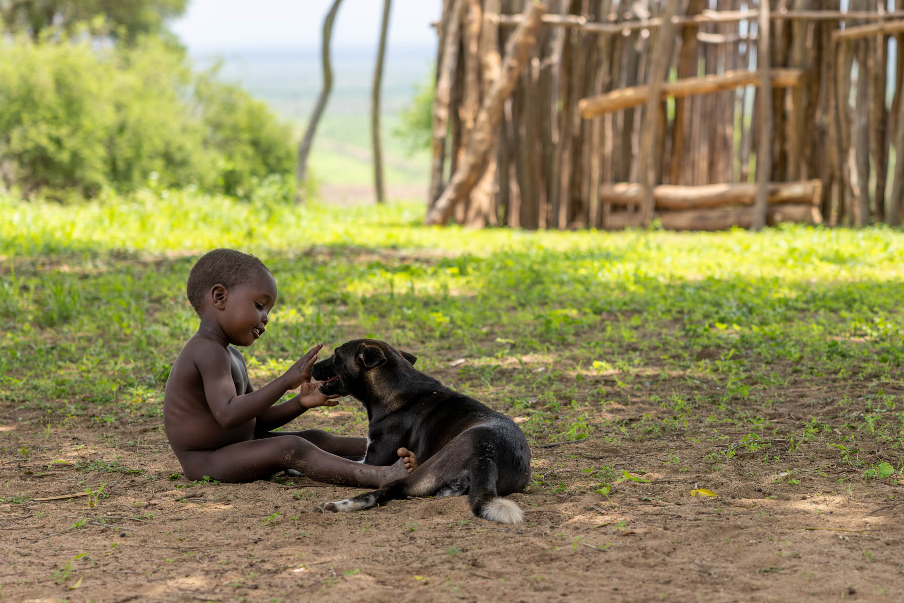 A tender moment between a young Kara boy and his dog. (image by Ingrid Koedood)