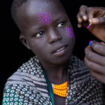 A young Kara girl as her face paint is carefully applied. (image by Ingrid Koedood)