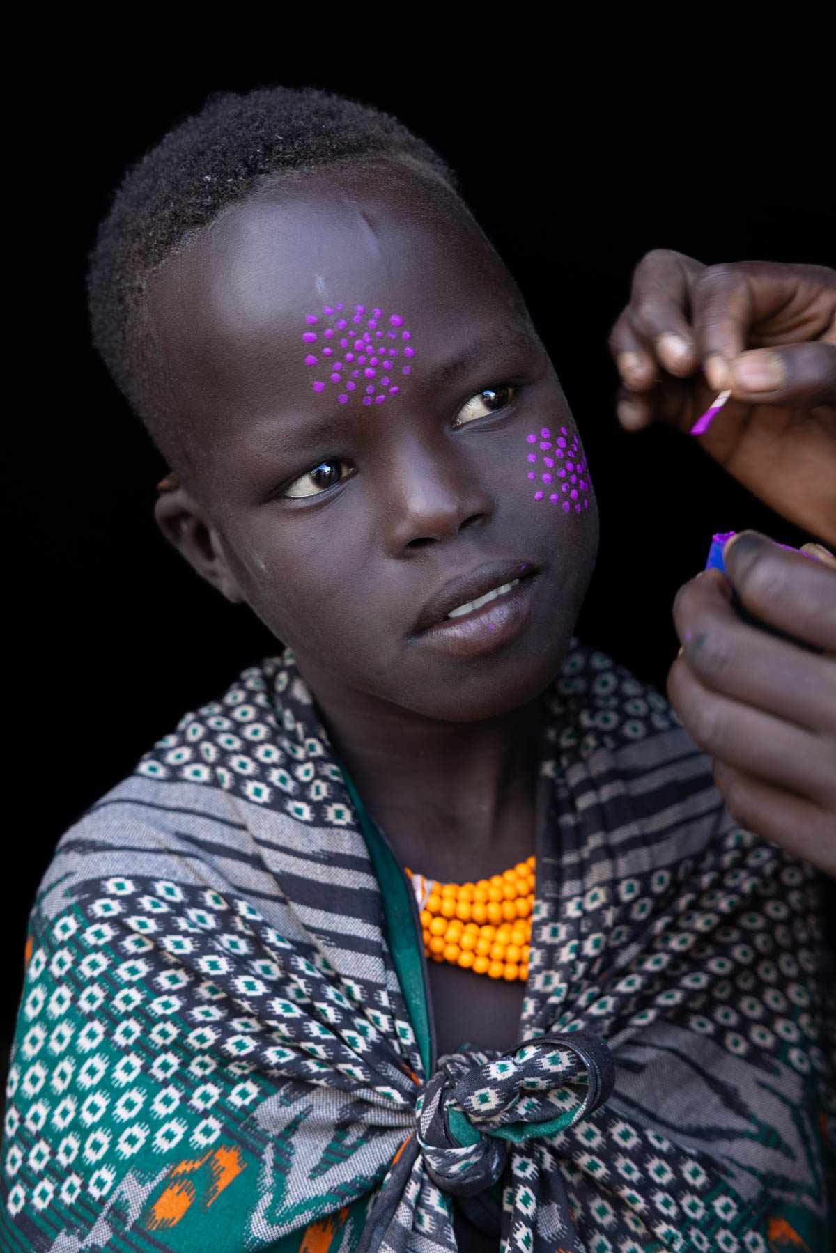 A young Kara girl as her face paint is carefully applied. (image by Ingrid Koedood)