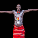 With a wide smile, a Kara man shows just how tall he is. (image by Ingrid Koedood)