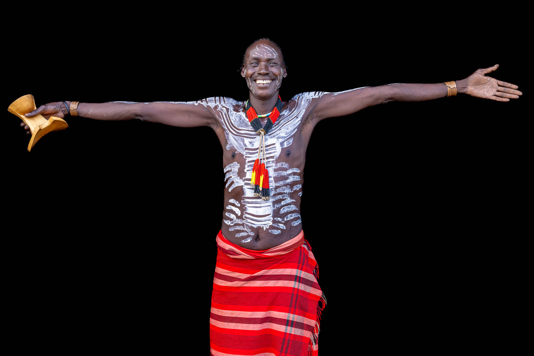 With a wide smile, a Kara man shows just how tall he is. (image by Ingrid Koedood)