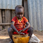 A young Kara boy eating his breakfast. (image by Ingrid Koedood)