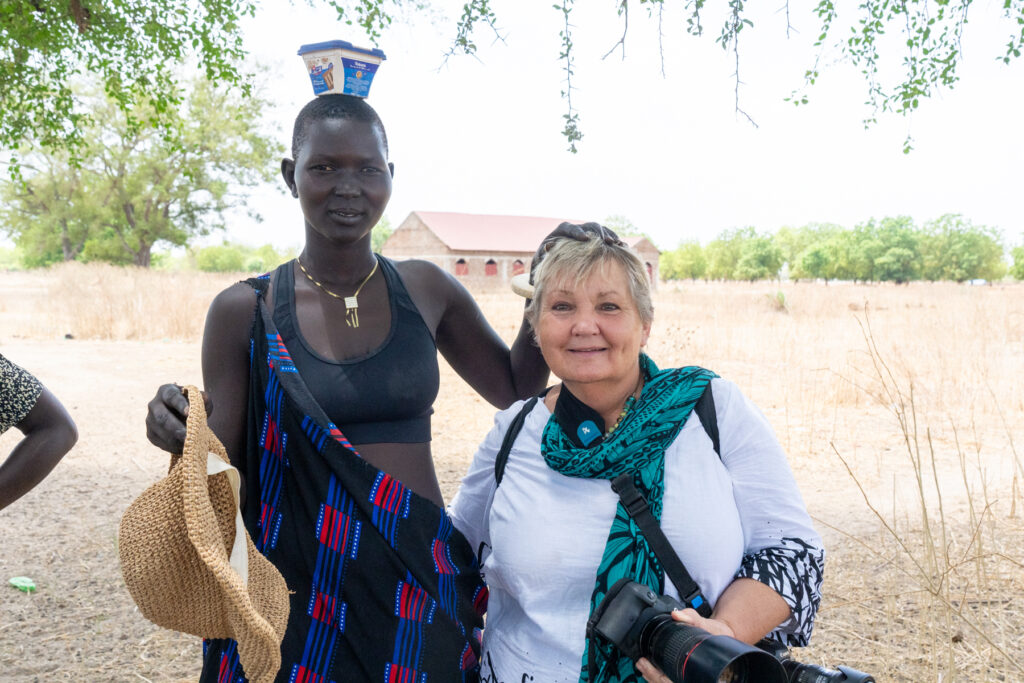 Katie enjoying a hat shuffle with a local Mundari woman (image by Inger Vandyke)