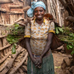 With a big smile, even while carrying the weight of the day – Konso. (image by Ingrid Koedood)