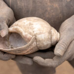 Mundari children make toys out of simple things like land snail shells (image by Inger Vandyke)