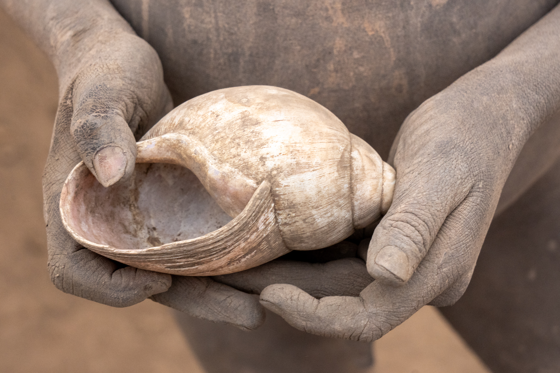 Mundari children make toys out of simple things like land snail shells (image by Inger Vandyke)