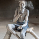 A Mundari boy powders his nose (image by Inger Vandyke)