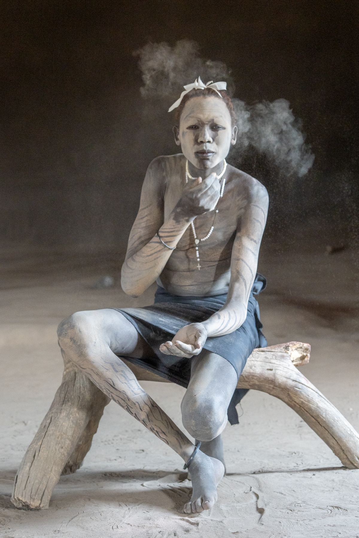 A Mundari boy powders his nose (image by Inger Vandyke)