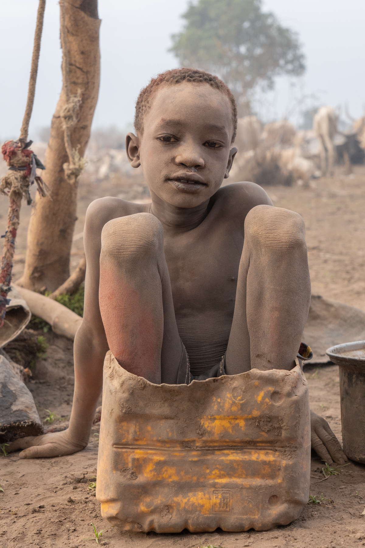 Tiny Mundari boy in a bucket (image by Inger Vandyke)