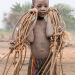 Smiling Mundari boy with tethering ropes (image by Inger Vandyke)
