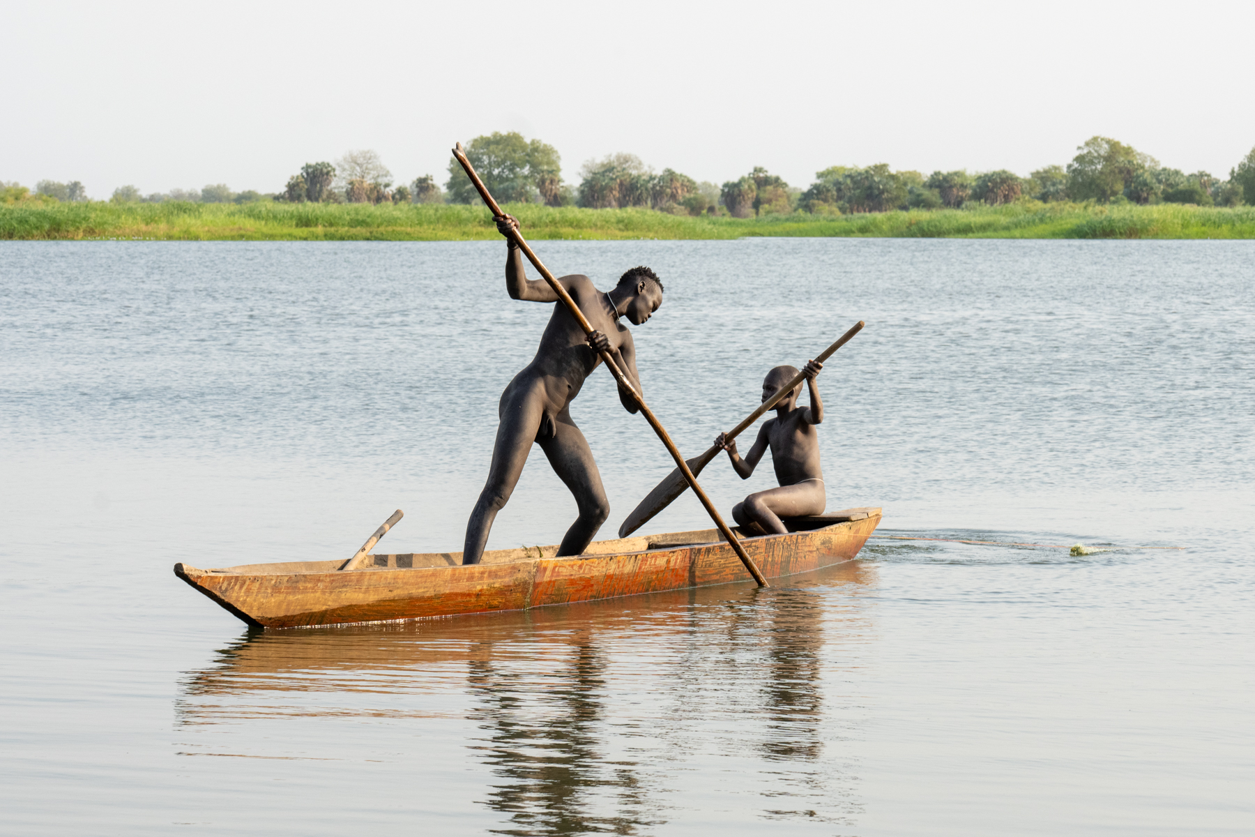 Mundari fishermen in their dugout canoe (image by Inger Vandyke)