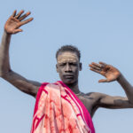 Young Mundari man dressed up for a wrestling match (image by Inger Vandyke)