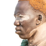 Mundari man with traditional clay bun (image by Inger Vandyke)