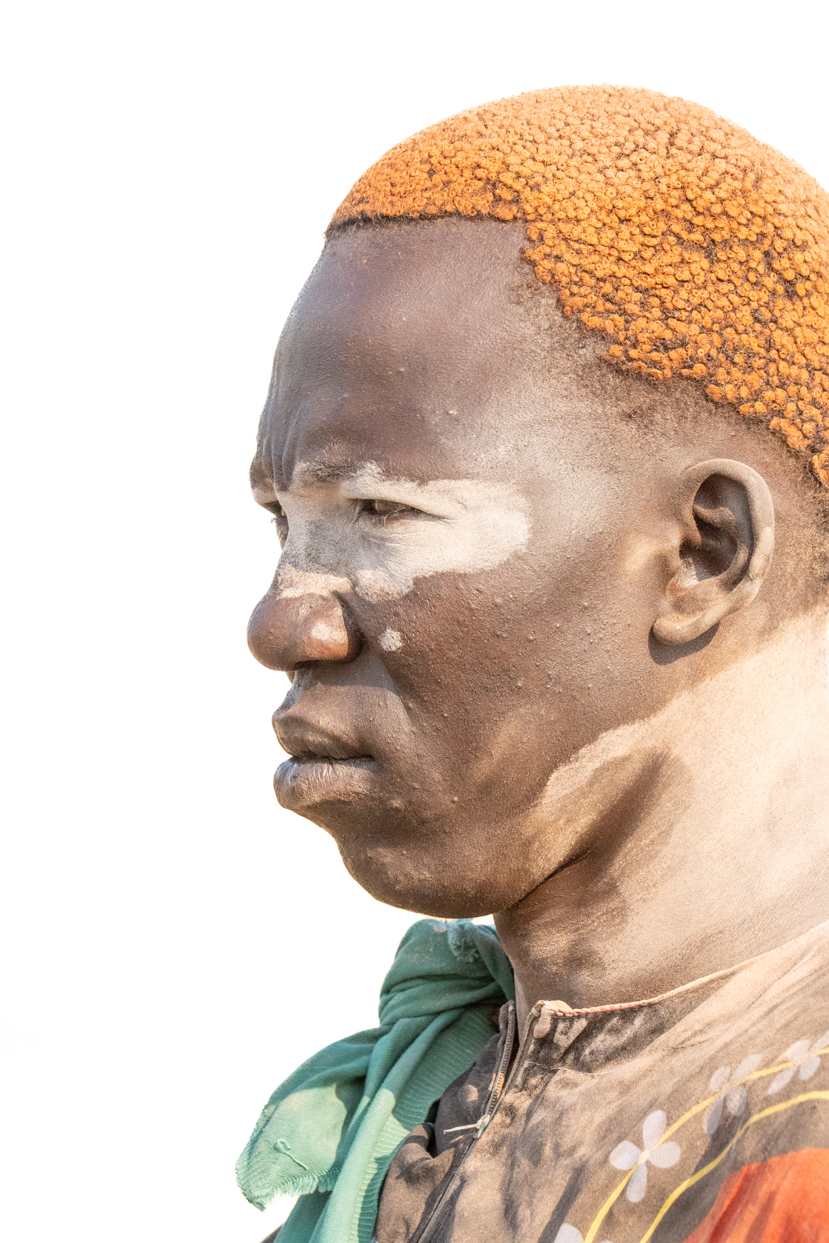 Mundari man with traditional clay bun (image by Inger Vandyke)