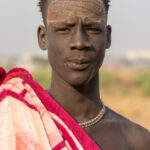 Mundari men paint their faces for traditional celebrations (image by Inger Vandyke)