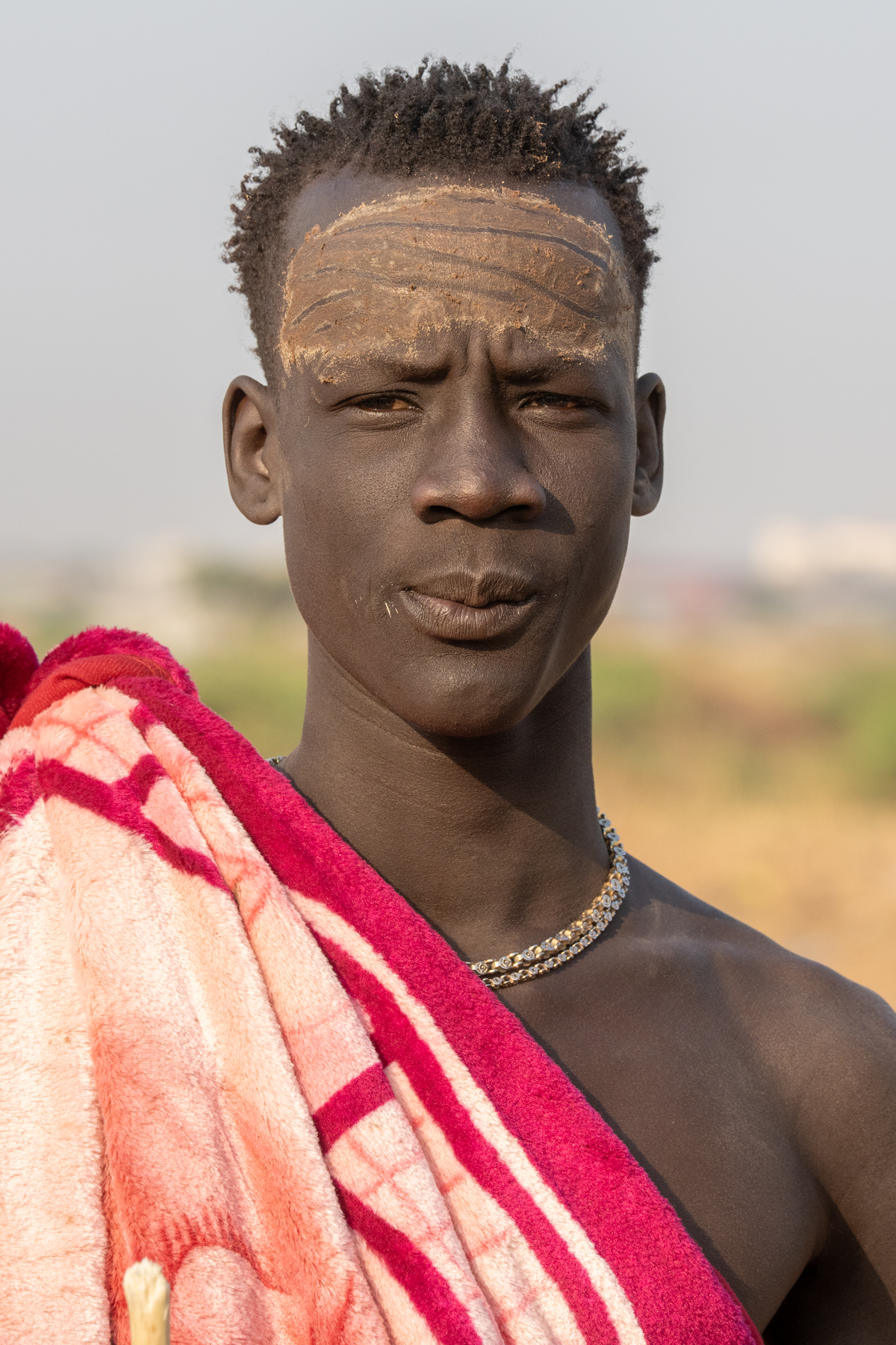 Mundari men paint their faces for traditional celebrations (image by Inger Vandyke)