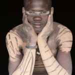 Mundari man with clay decoration (image by Inger Vandyke)