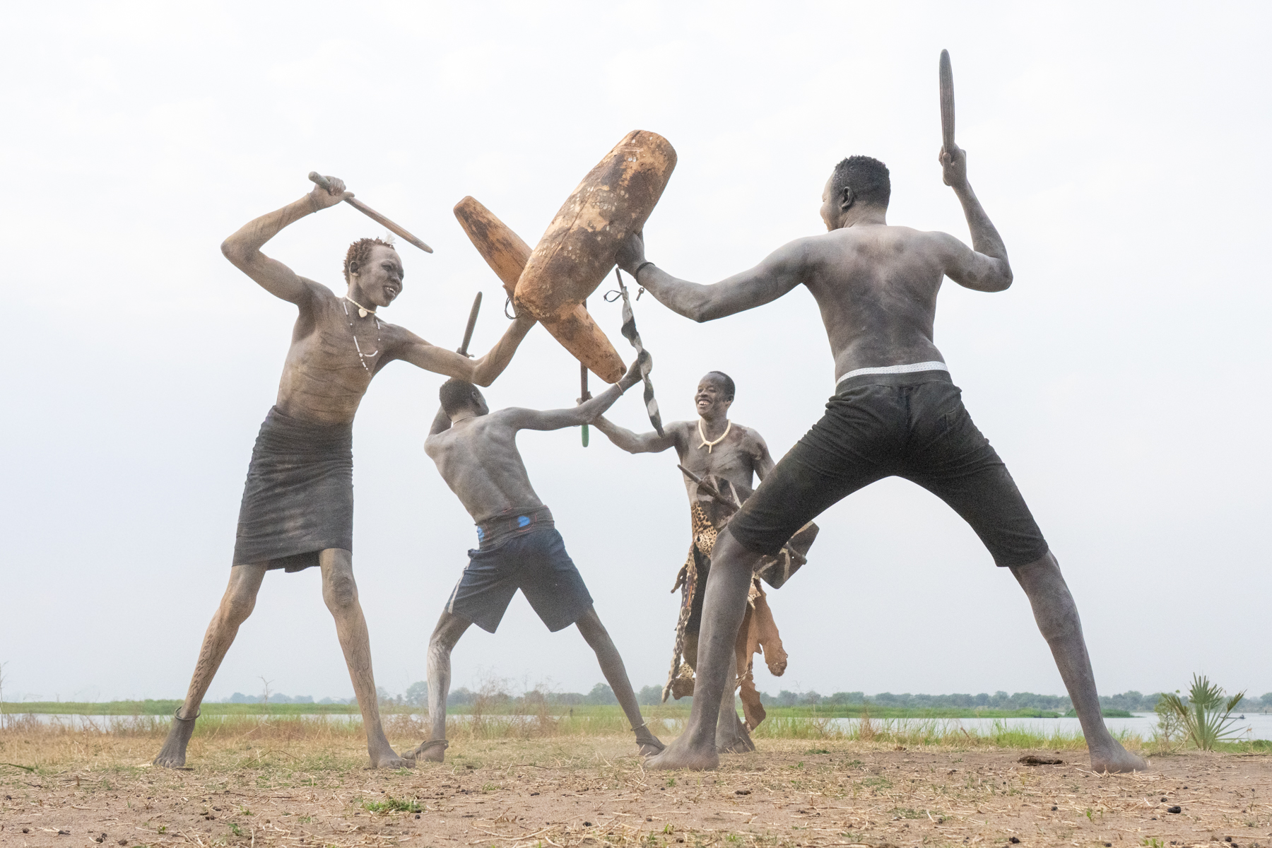 Mundari men practicing fighting using traditional guards, shields and clubs (image by Inger Vandyke)