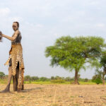 Young Mundari man with traditional leopard skin and spear (image by Inger Vandyke)