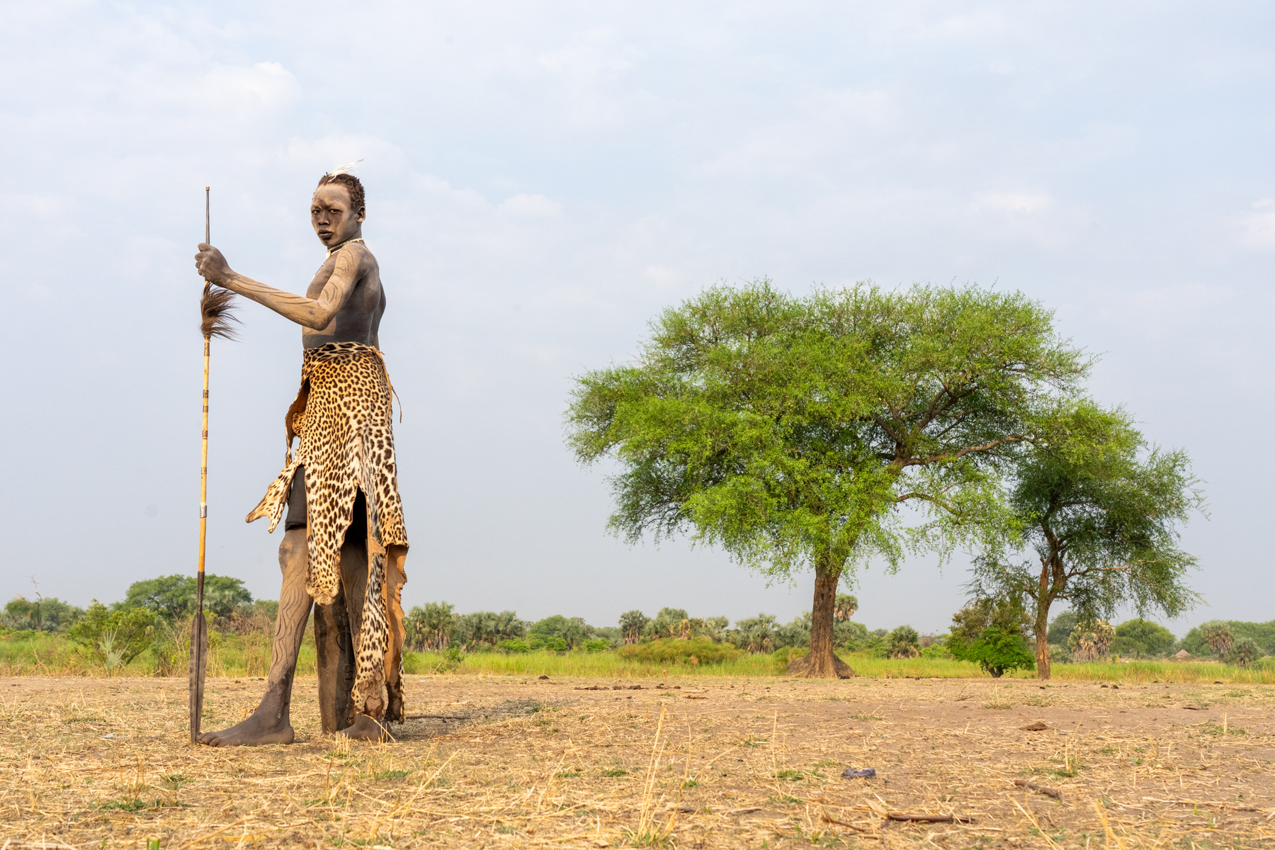 Young Mundari man with traditional leopard skin and spear (image by Inger Vandyke)