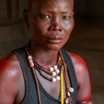 Mundari woman wearing the red ochre she would normally use in ceremonies (image by Inger Vandyke)