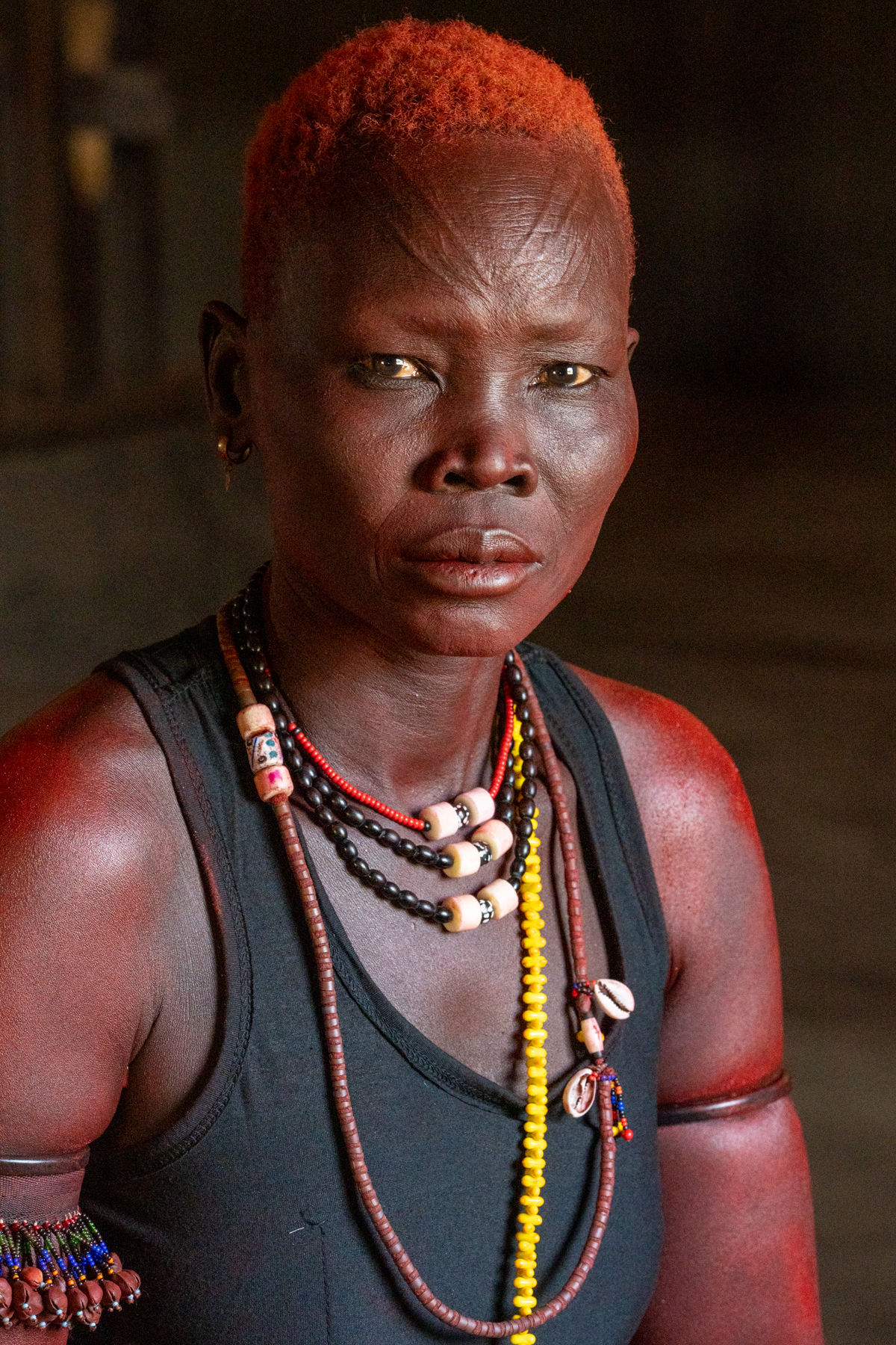 Mundari woman wearing the red ochre she would normally use in ceremonies (image by Inger Vandyke)