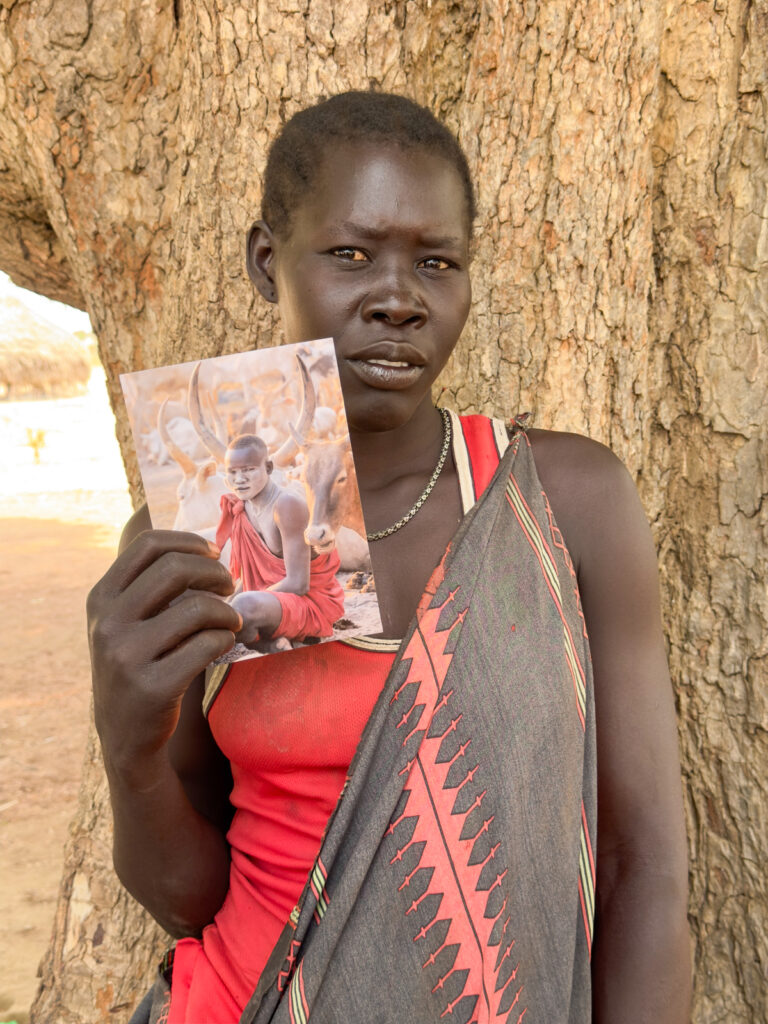 Bidi holding a photo of Gore, her brother in law (image by Inger Vandyke)