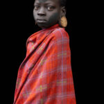 Mursi girl, wrapped in a traditional cloth, her face marked with natural pigments. (image by Ingrid Koedood)