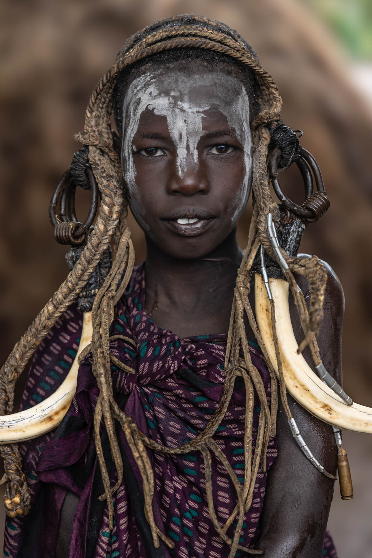Warm colors, strong presence, a young Mursi girl wrapped in textures of tradition. (image by Ingrid Koedood)