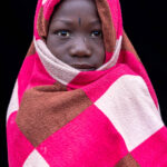 A young Nyangatom girl wrapped in pink. (image by Ingrid Koedood)