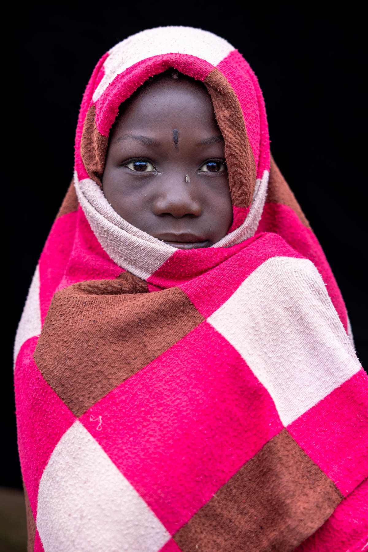 A young Nyangatom girl wrapped in pink. (image by Ingrid Koedood)