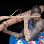 Portrait of a Mundari man playing Tung (image by Inger Vandyke)